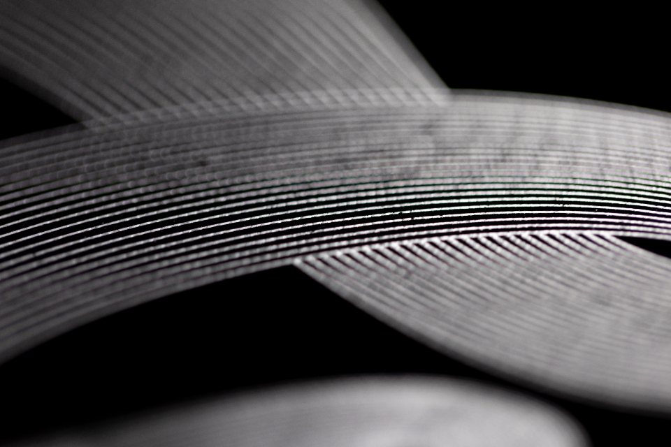 Overlapping curves of textured metal in black and white