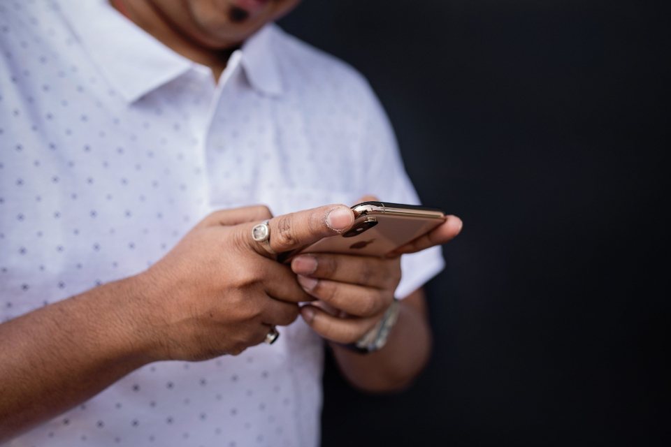 Close view of hands using a smartphone