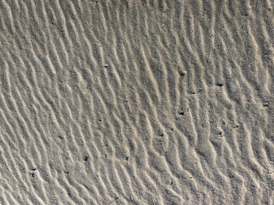 Naturally rippled sand with fine parallel ridges